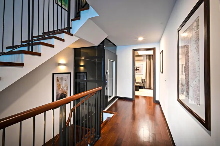 Sleek modern corridor staircase featuring wooden